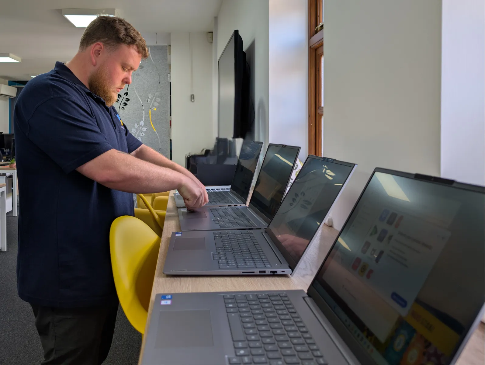A Confidence IT engineer setting up business laptops