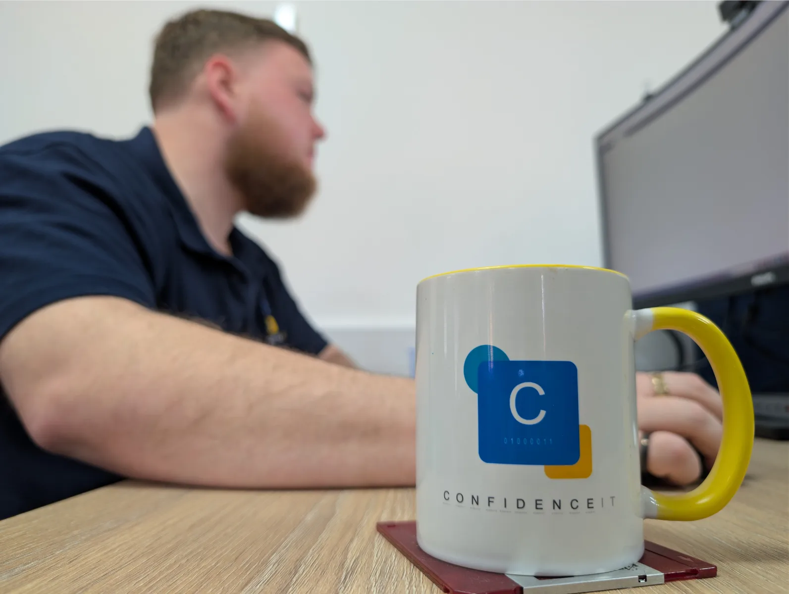 A Confidence IT team member talking with a client in the office