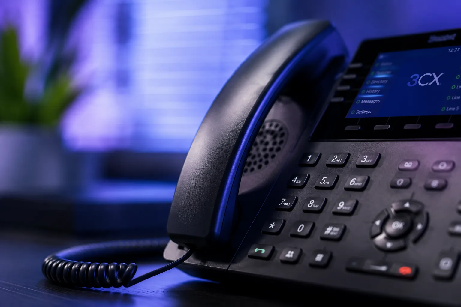 A 3CX VoIP desk phone on an office desk